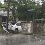 Car smashes into wall, brings down two poles Car smashes into wall, brings down two poles
